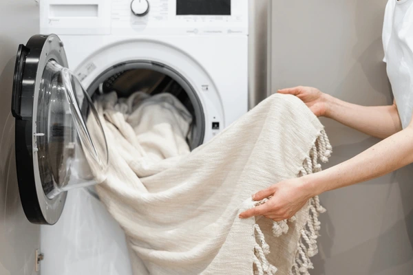 cropped-view-woman-unloading-laundry-600nw-2178807931
